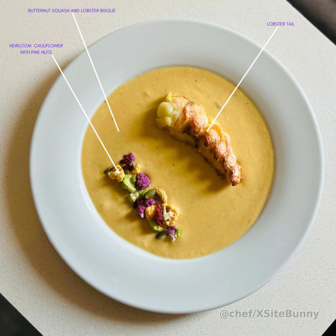 Comfort and elegance in one bowl.

This butternut squash and lobster bisque is rich, velvety, and deeply layered—crowned with a perfectly poached lobster tail and garnished with heirloom cauliflower and toasted pine nuts for color, crunch, and contrast.

A refined dish that warms the soul and celebrates the sea.